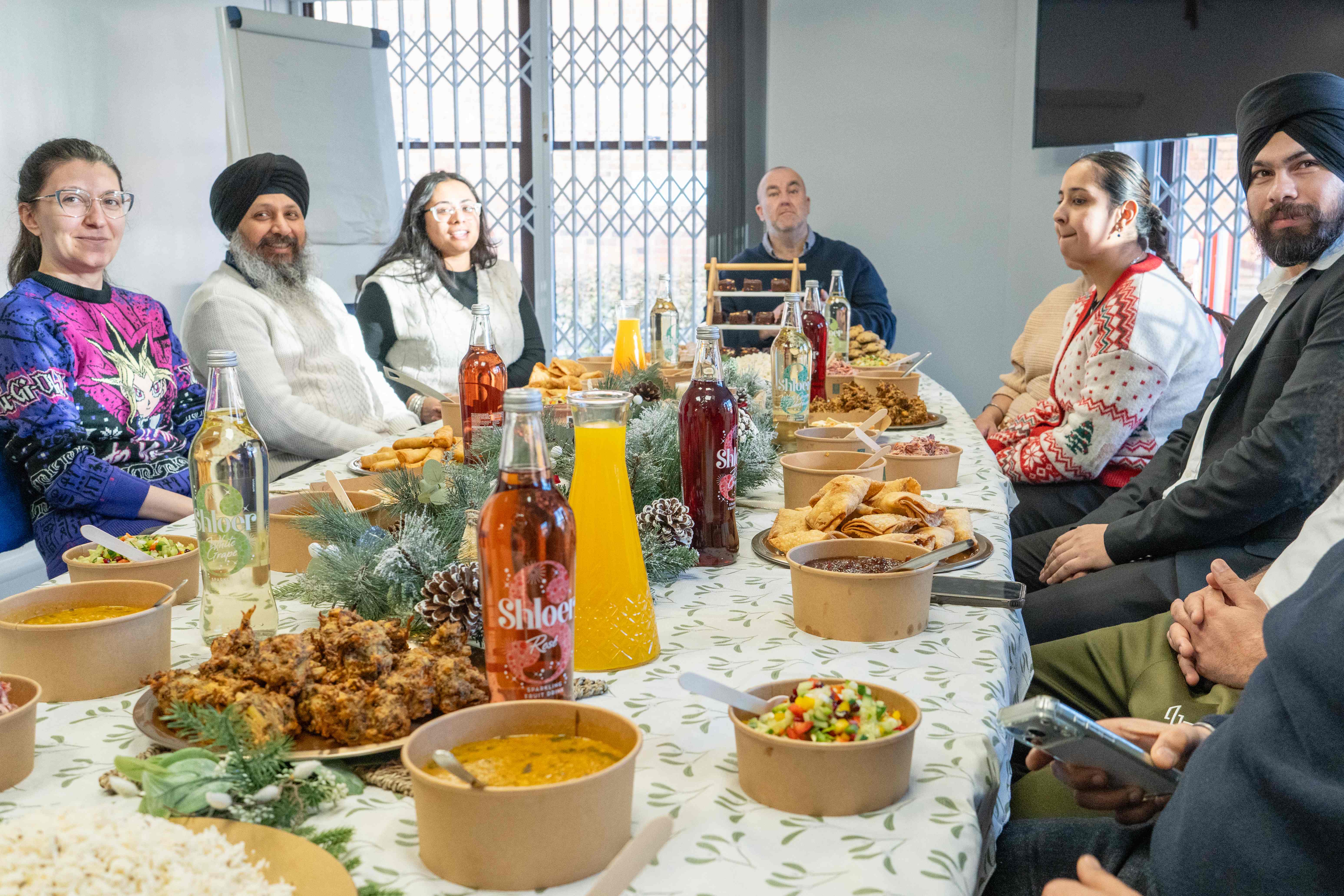 Team gathered around festive Indian lunch